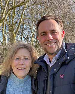 A picture of Catherine Keattch and Sam Cremnitz with Apsen trees in the background