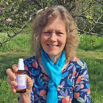Catherine with a bottle of Flower Essences Catherine with a flower essence spray