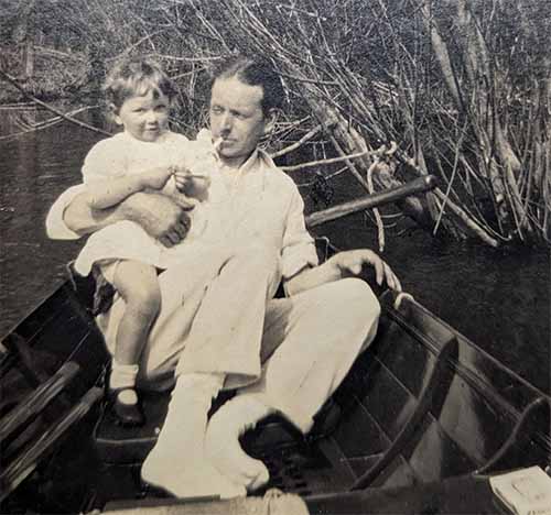 Picture of Dr Edward Bach sitting in a boat with his daughter Bobbie