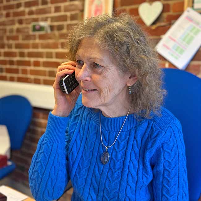 Picture of Catherine Keattch on the phone at Crystal Herbs