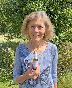 Picture of Catherine Keattch holding a Heart Connection Essence spray