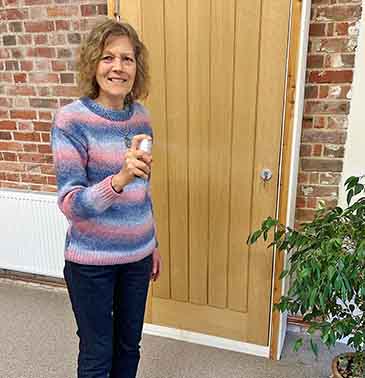 Catherine using a flower essence space clearing spray