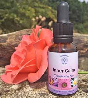 Inner Calm Essence on wood with a flower