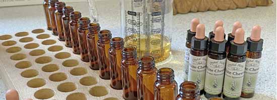 Handmaking the Bach Remedies Hand pouring White Chestnut Remedy - bottles, pouring jug, completed remedies